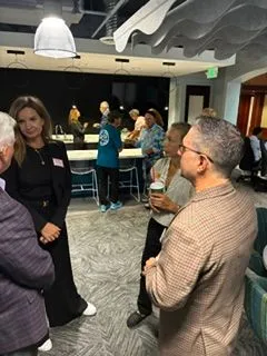Group talking with name tags in a modern office lounge