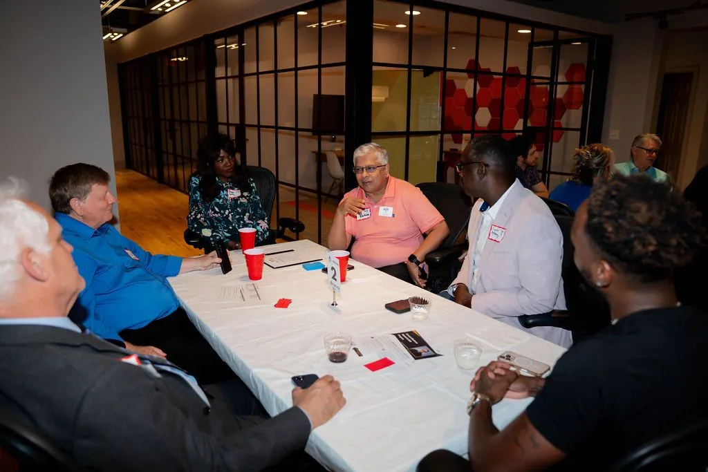 Professionals collaborating in a glass meeting room